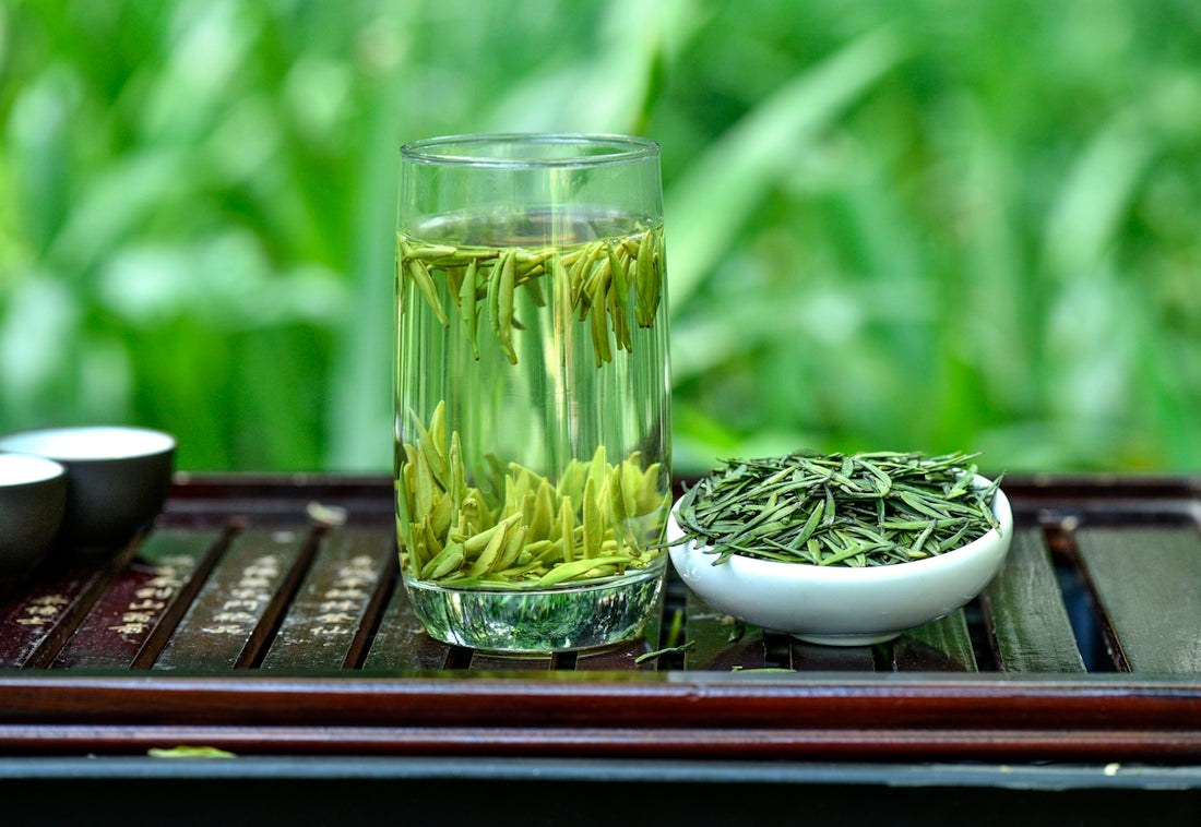a glass of green tea next to a bowl of green tea