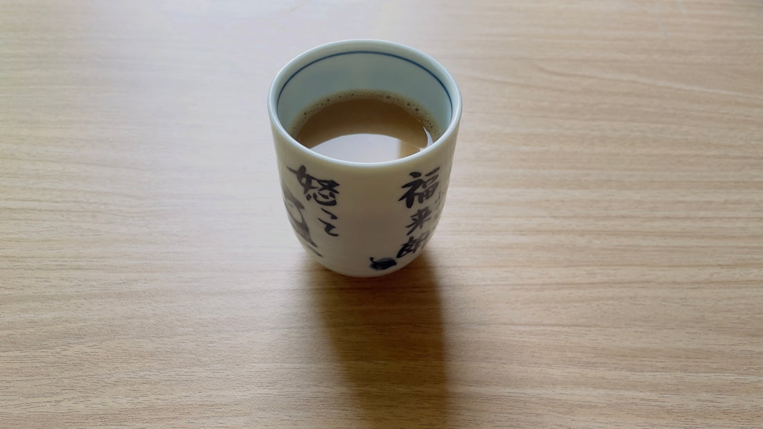A coffee cup sitting on top of a wooden table