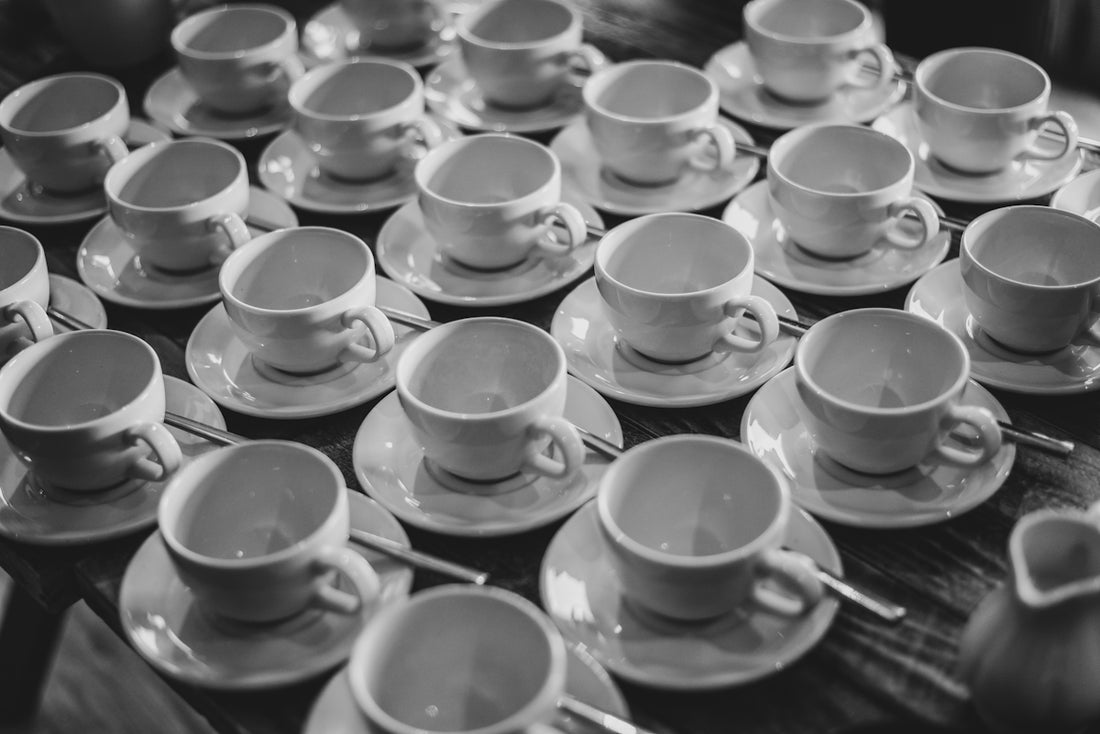 A table topped with lots of cups and saucers