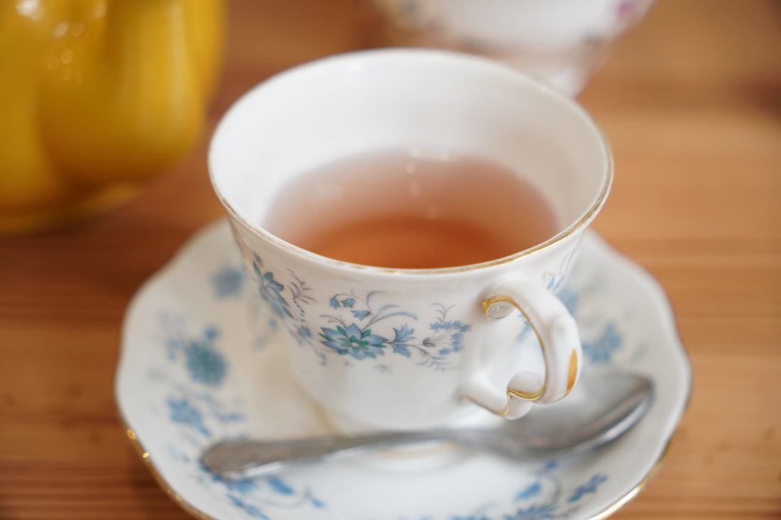 Tea is served in a floral teacup and saucer.