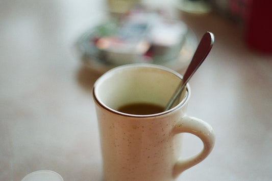 white ceramic mug with stainless steel spoon