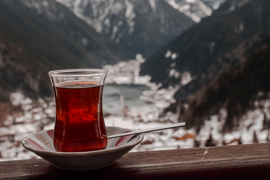 a cup of tea sitting on top of a white plate