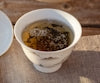 a cup of tea is sitting on a table