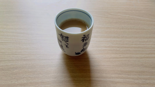 A coffee cup sitting on top of a wooden table