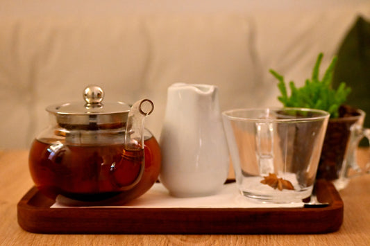 A tray with glasses and a tea pot on it