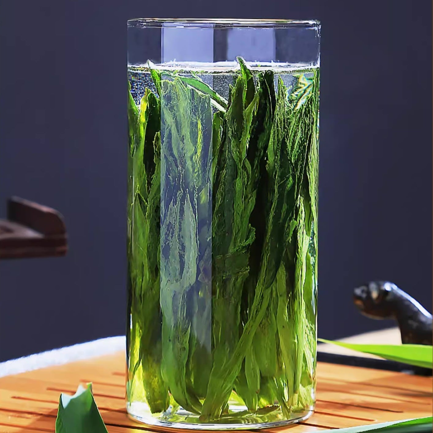 Tai Ping Hou Kui leaves brewing in a glass