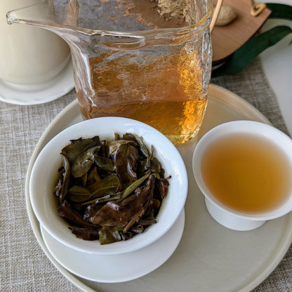 Shou Mei tea leaves and amber liquor